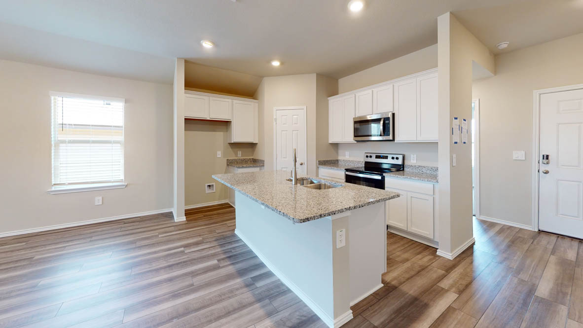 596 Hector Loop Georgetown, TX 78626 - Photo 2 of 14 A well-lit kitchen with modern appliances and ample counter space is perfect for culinary endeavors.