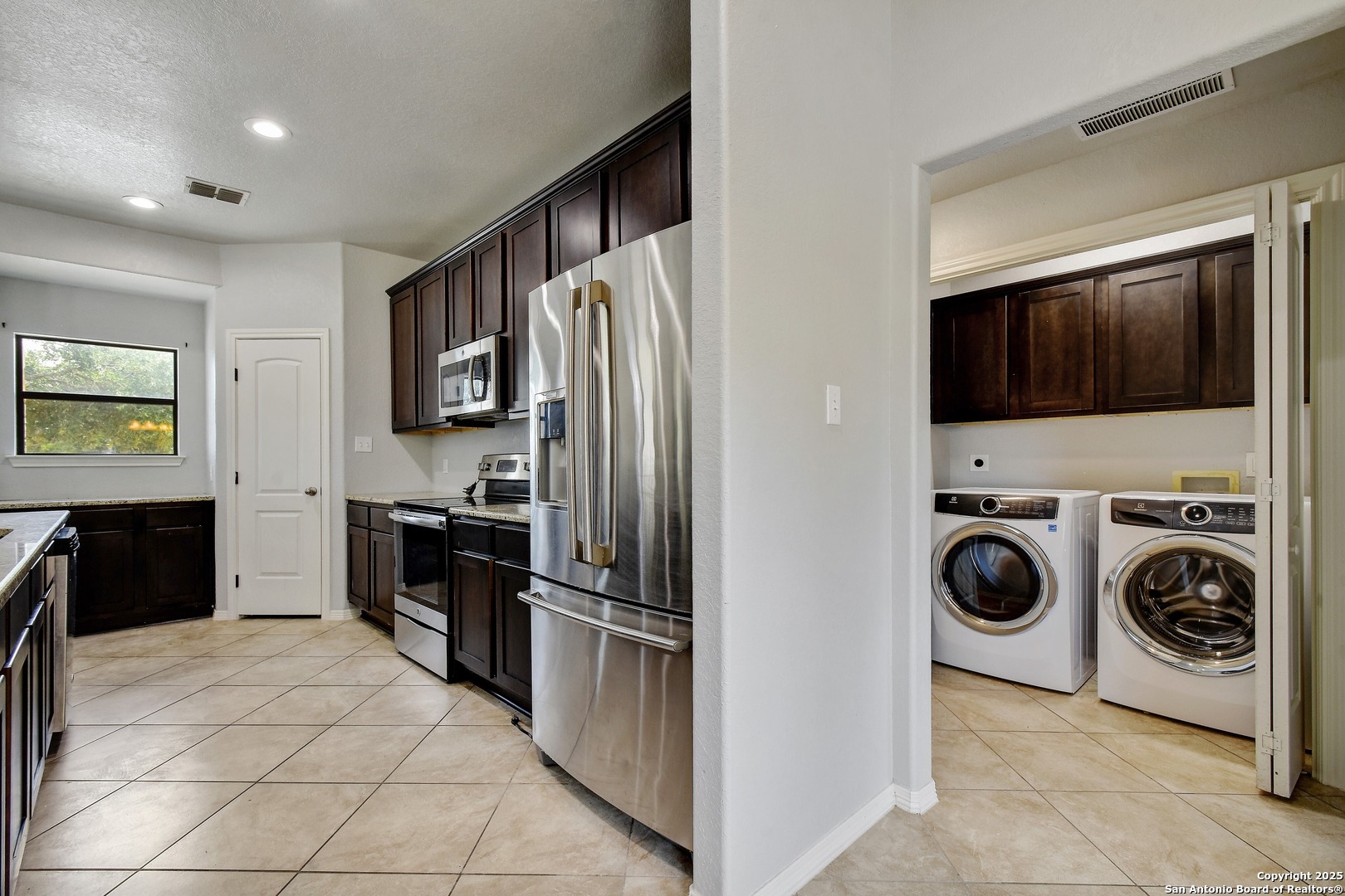 1010 Persimmon Pass Fischer, TX 78623 - Photo 12 of 26 a kitchen with stainless steel appliances granite countertop a refrigerator and a stove top oven