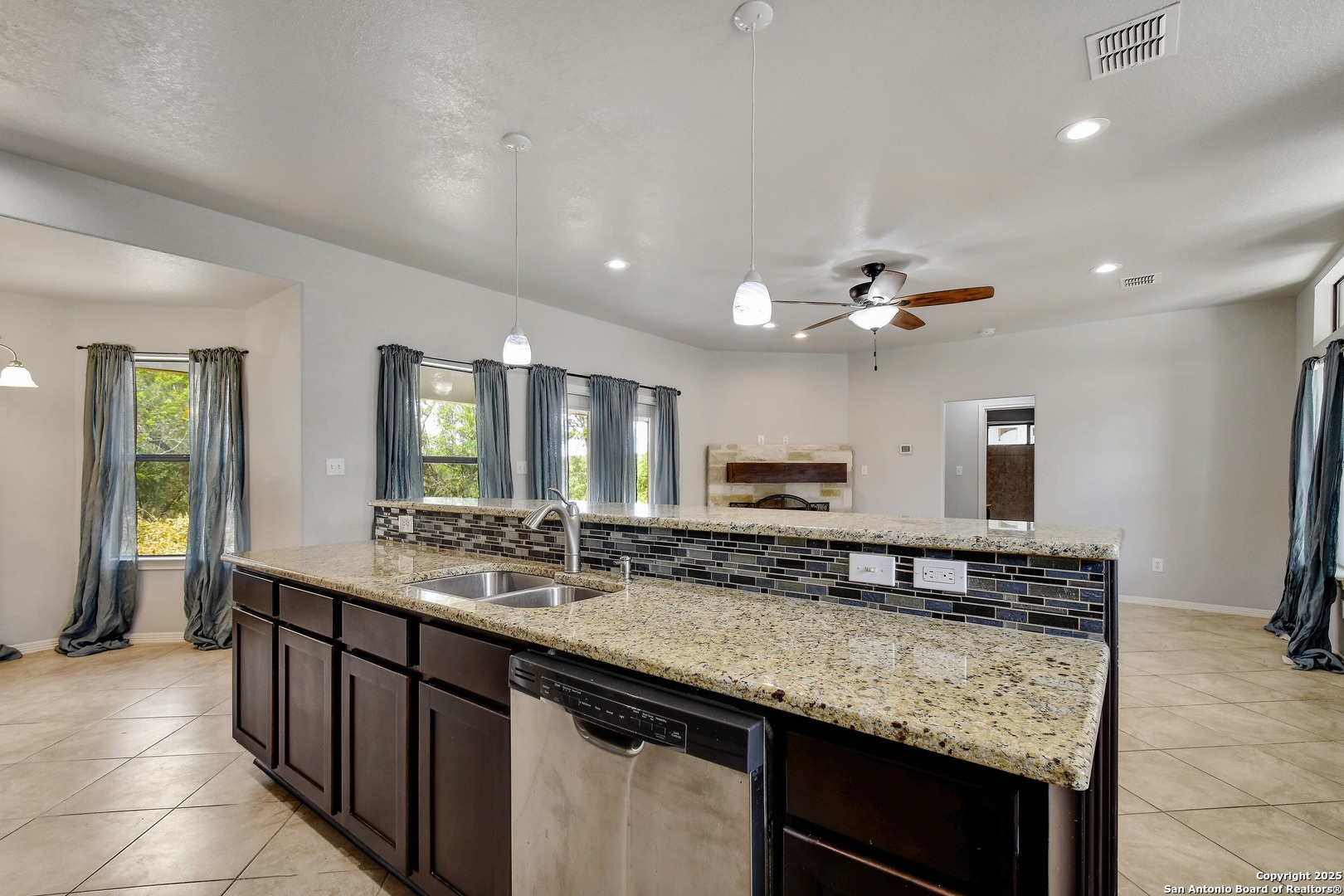 1010 Persimmon Pass Fischer, TX 78623 - Photo 10 of 26 a bathroom with a granite countertop sink a large mirror and a refrigerator