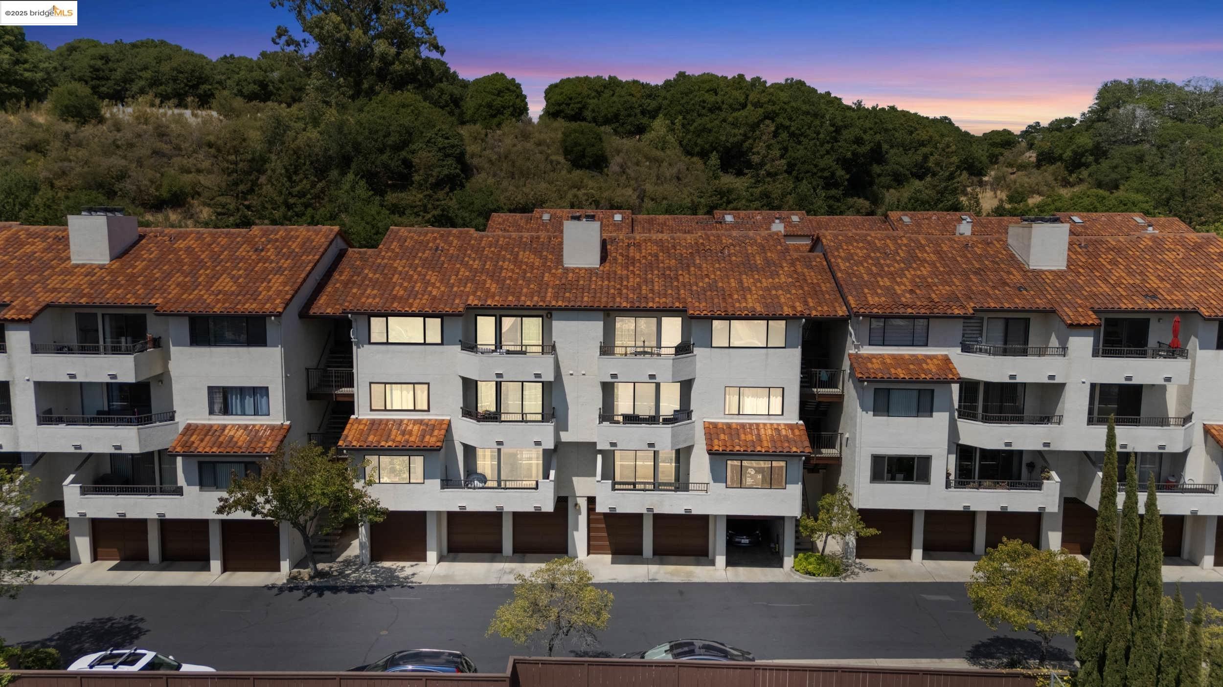 a aerial view of a large residential apartment building with a yard in front of it