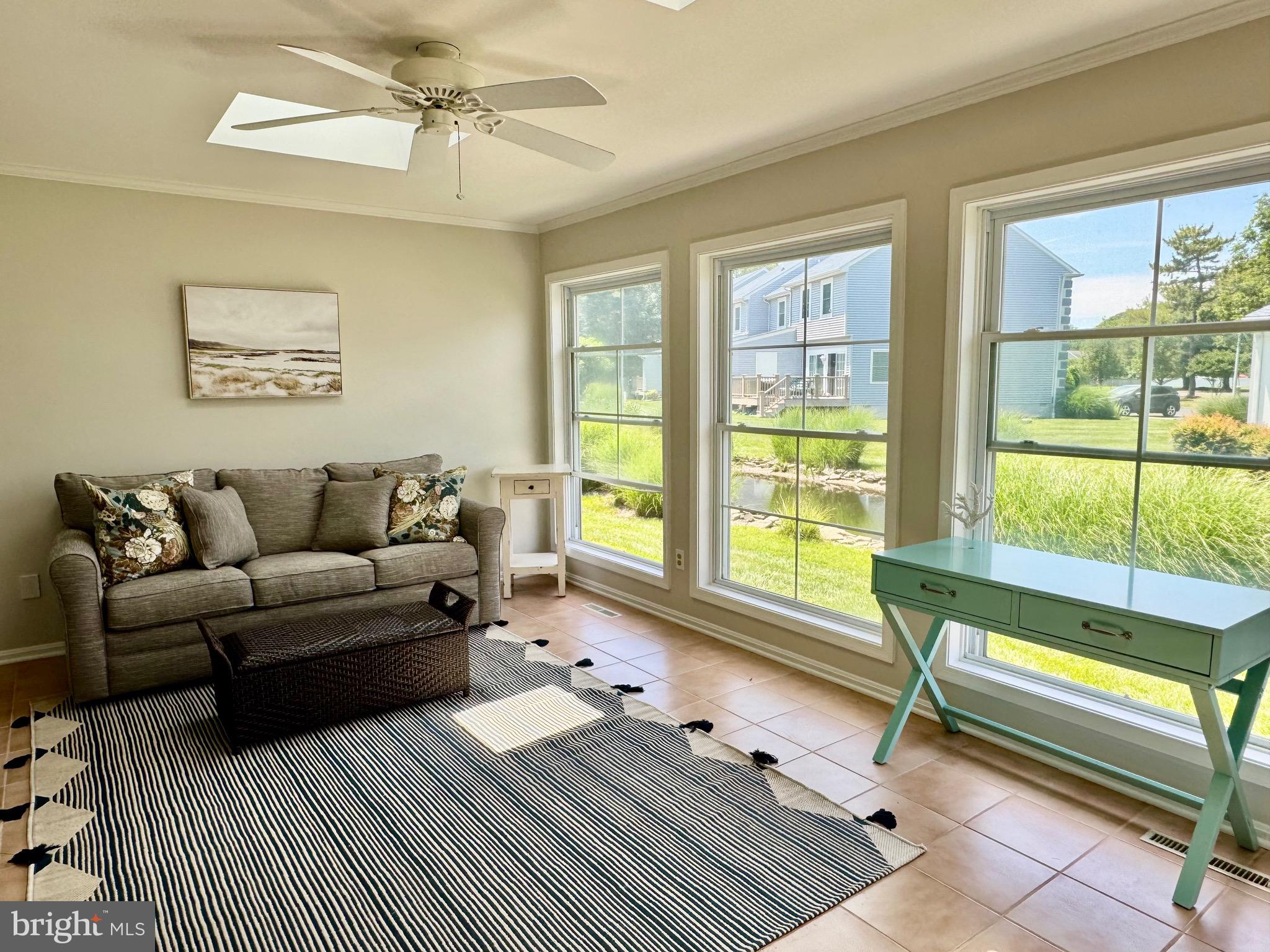 280 American Eagle Way, Unit 2806 Rehoboth Beach, DE 19971 - Photo 12 of 41 a living room with furniture and a large window