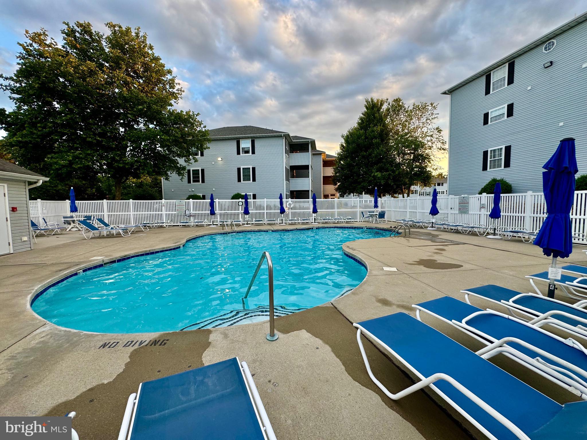 280 American Eagle Way, Unit 2806 Rehoboth Beach, DE 19971 - Photo 37 of 41 a swimming pool with outdoor seating and yard in the back
