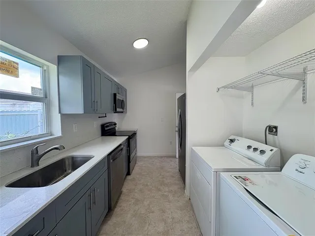 a kitchen that has a sink and a stove