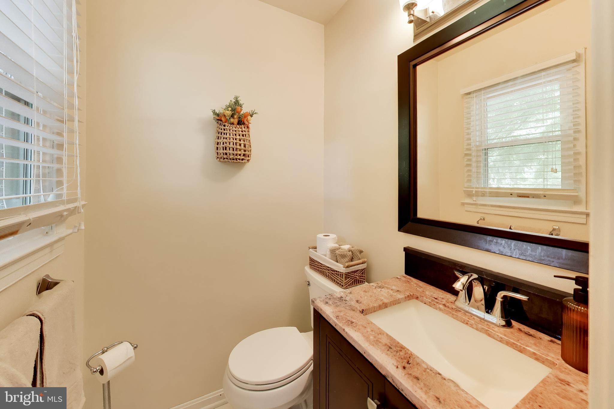 3240 Juniper Lane Huntingtown, MD 20639 - Photo 9 of 48 a bathroom with a granite countertop toilet sink and mirror