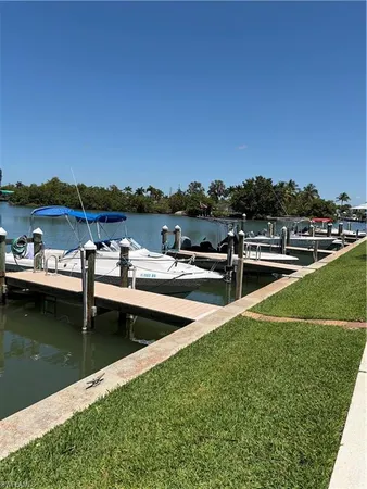 a view of a lake with couches chairs