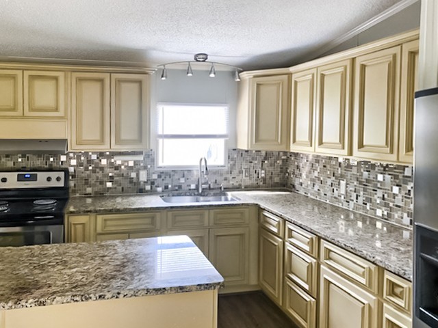 273 Running Meadows Road Portland, TN 37148 - Photo 10 of 20 a kitchen with a stove a sink and a refrigerator