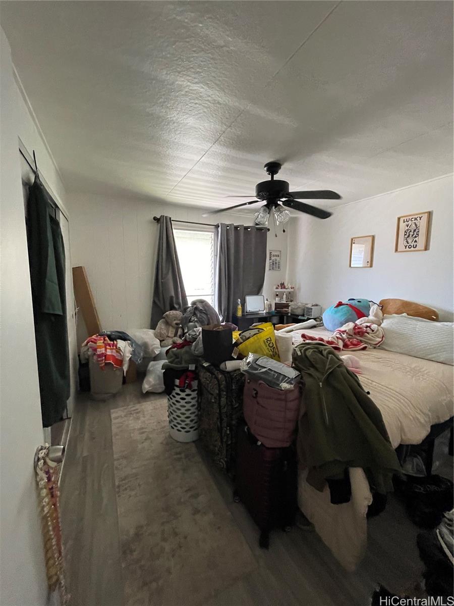 720 Mahiai Street Honolulu, HI 96826 - Photo 5 of 7 a bed room with a bed and a chair