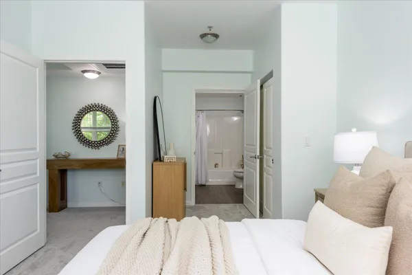 a bedroom with a bed and a mirror