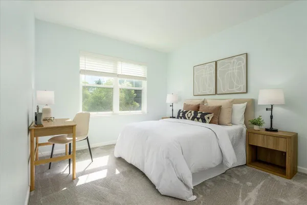 a bedroom with a bed and a table