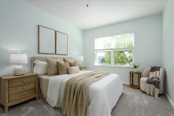 a bedroom with a bed and a couch