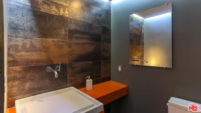 a living room with a couch and a potted plant