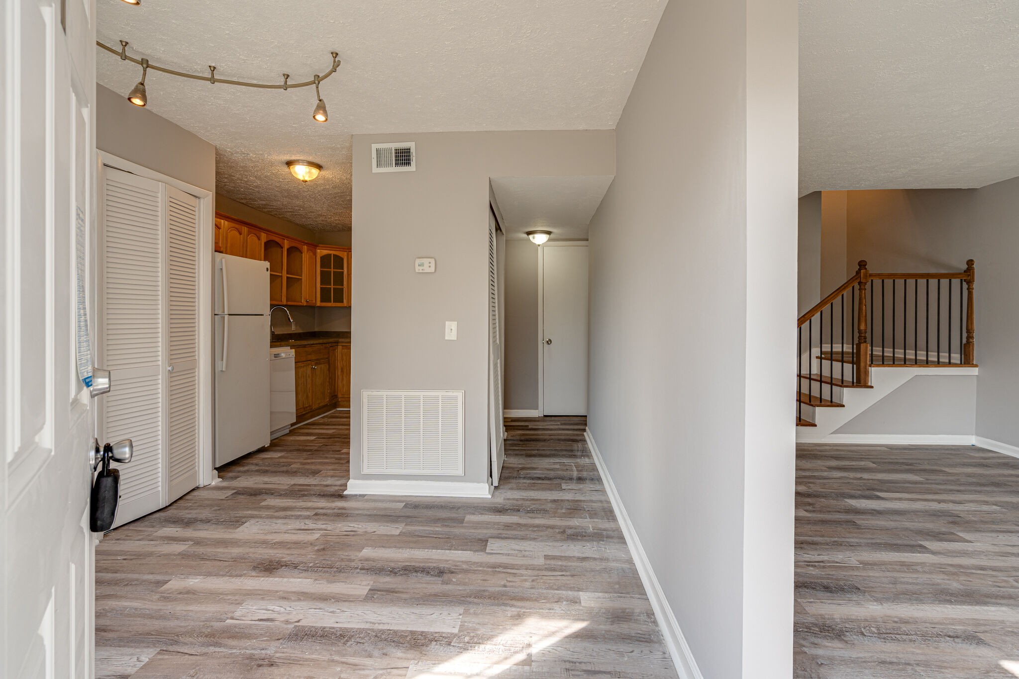 323 Forest Park Road, Unit 76 Madison, TN 37115 - Photo 1 of 15 a view of a hallway with wooden floor and staircase
