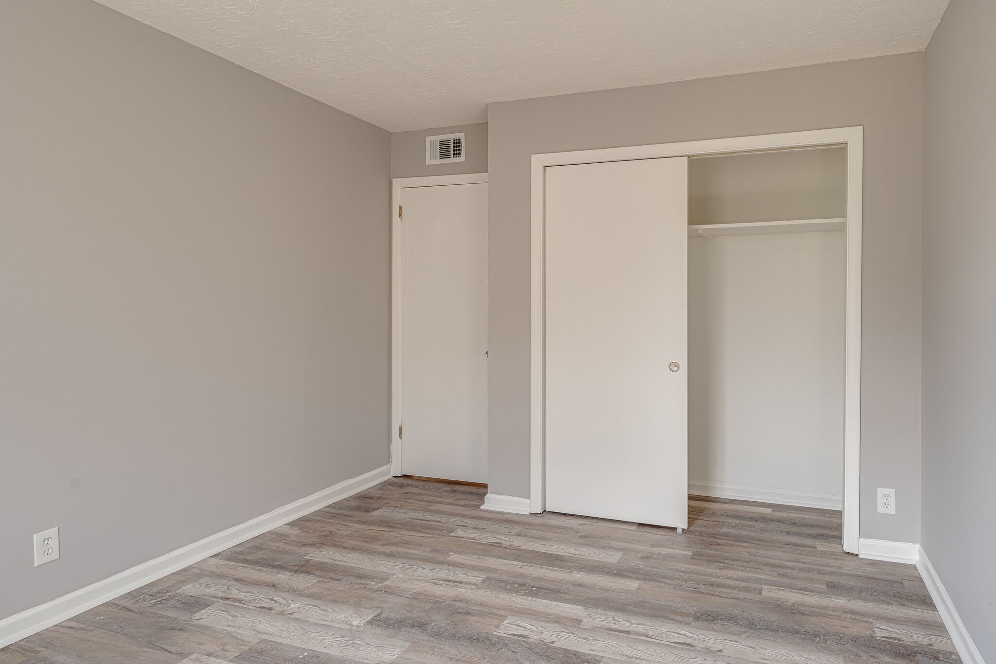 323 Forest Park Road, Unit 76 Madison, TN 37115 - Photo 11 of 15 a view of an empty room with wooden floor and closet