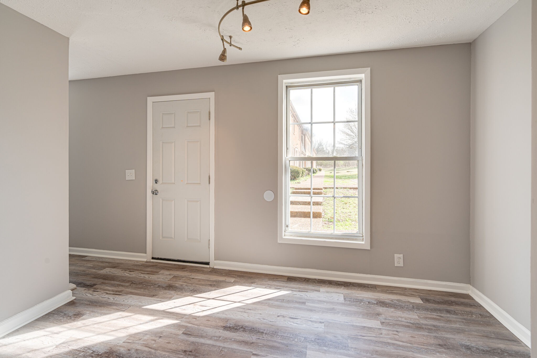 323 Forest Park Road, Unit 76 Madison, TN 37115 - Photo 2 of 15 a view of an empty room with wooden floor and a window