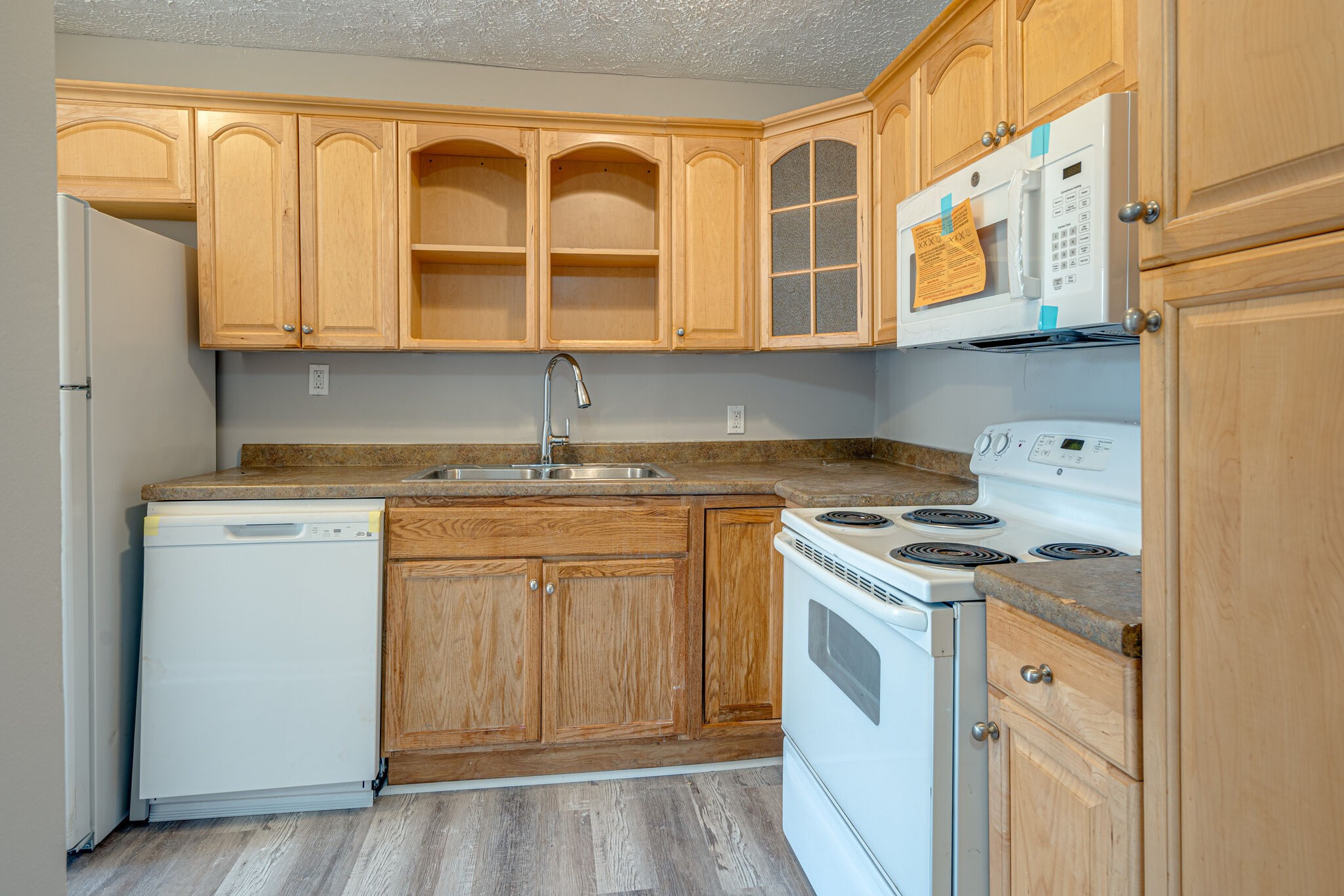 323 Forest Park Road, Unit 76 Madison, TN 37115 - Photo 5 of 15 a kitchen with stainless steel appliances granite countertop a stove and a white cabinets
