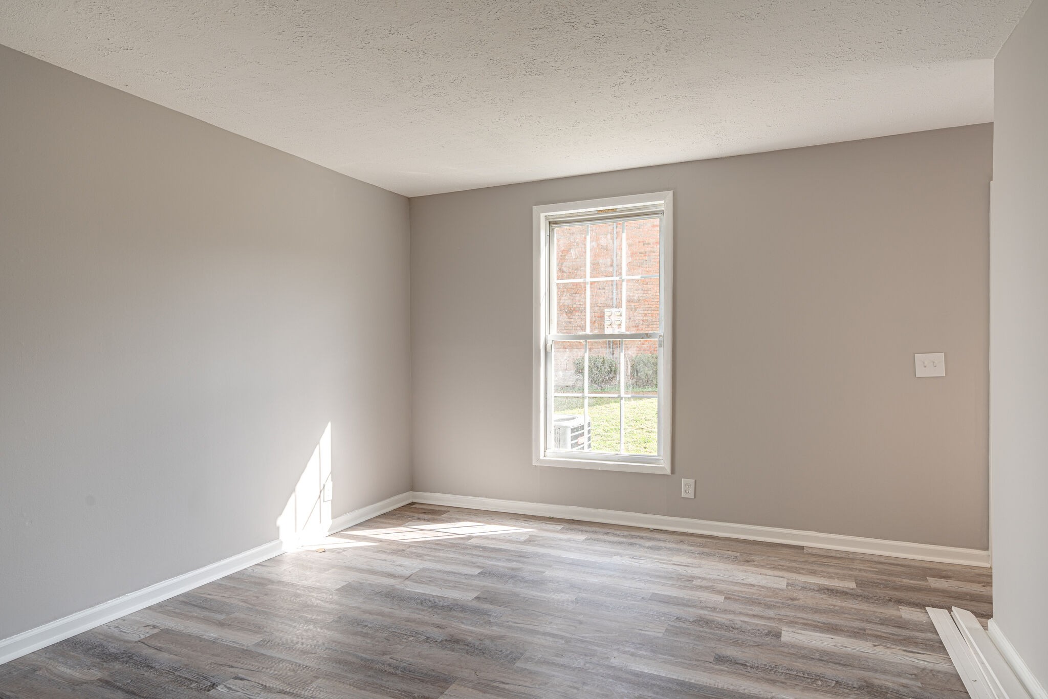 323 Forest Park Road, Unit 76 Madison, TN 37115 - Photo 9 of 15 an empty room with wooden floor and windows