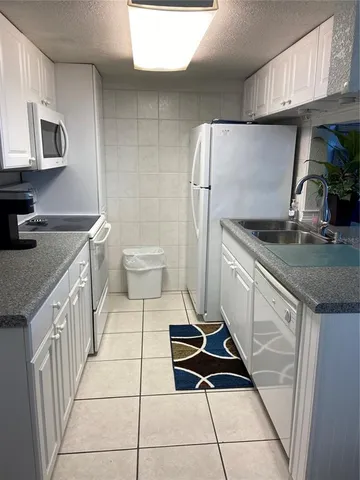 a white toilet sitting next to a white cabinet
