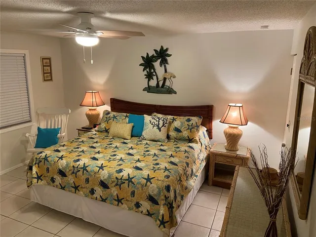 a view of a kitchen with fridge and furniture
