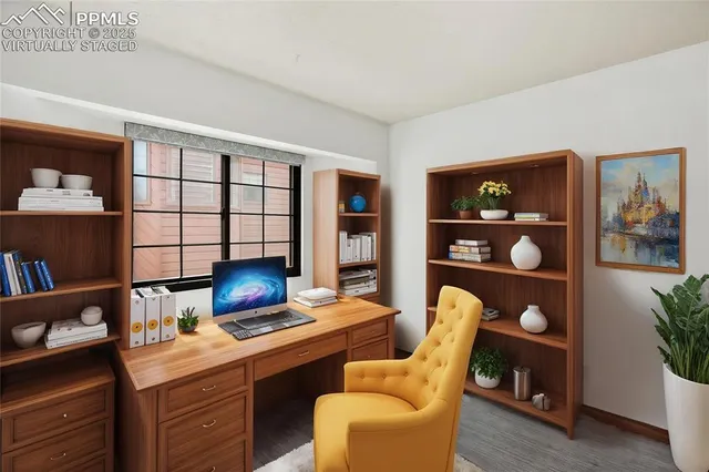 a living room with furniture a bookshelf and a window