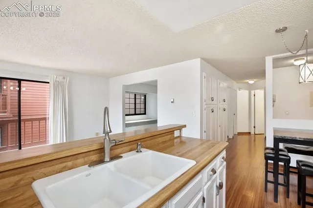 a room with a table chairs and a kitchen view