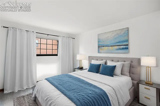 a bedroom with a bed and a lamp on dresser