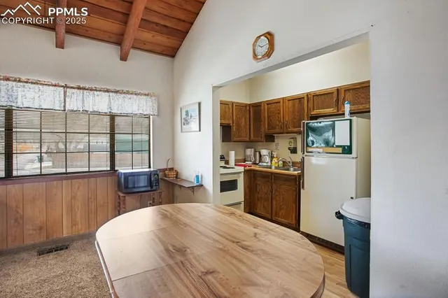 a kitchen with stainless steel appliances kitchen island granite countertop a refrigerator a stove top oven a sink and dishwasher