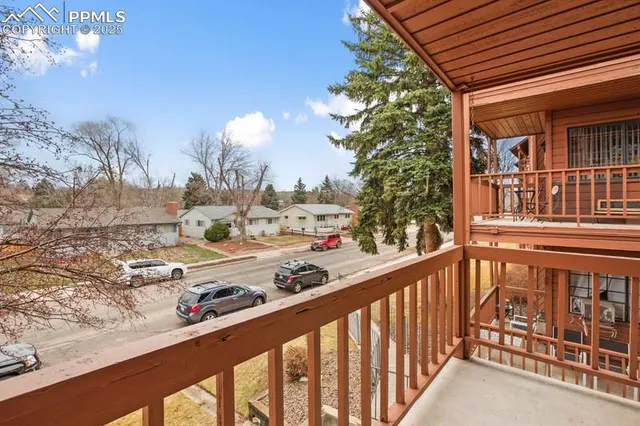 a view of a balcony with a yard