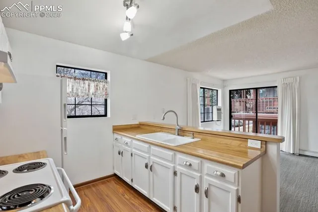 a kitchen with a sink stove and cabinets