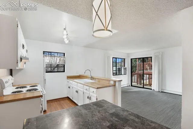 a living room with stainless steel appliances kitchen island granite countertop furniture and a kitchen view