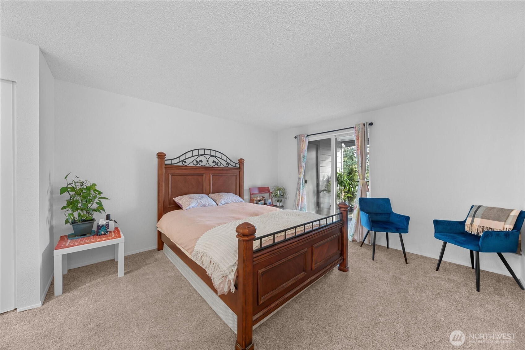 2515 Northeast 4th Street, Unit 522 Renton, WA 98056 - Photo 12 of 33 a bed sitting in a bedroom next to a window with a chair