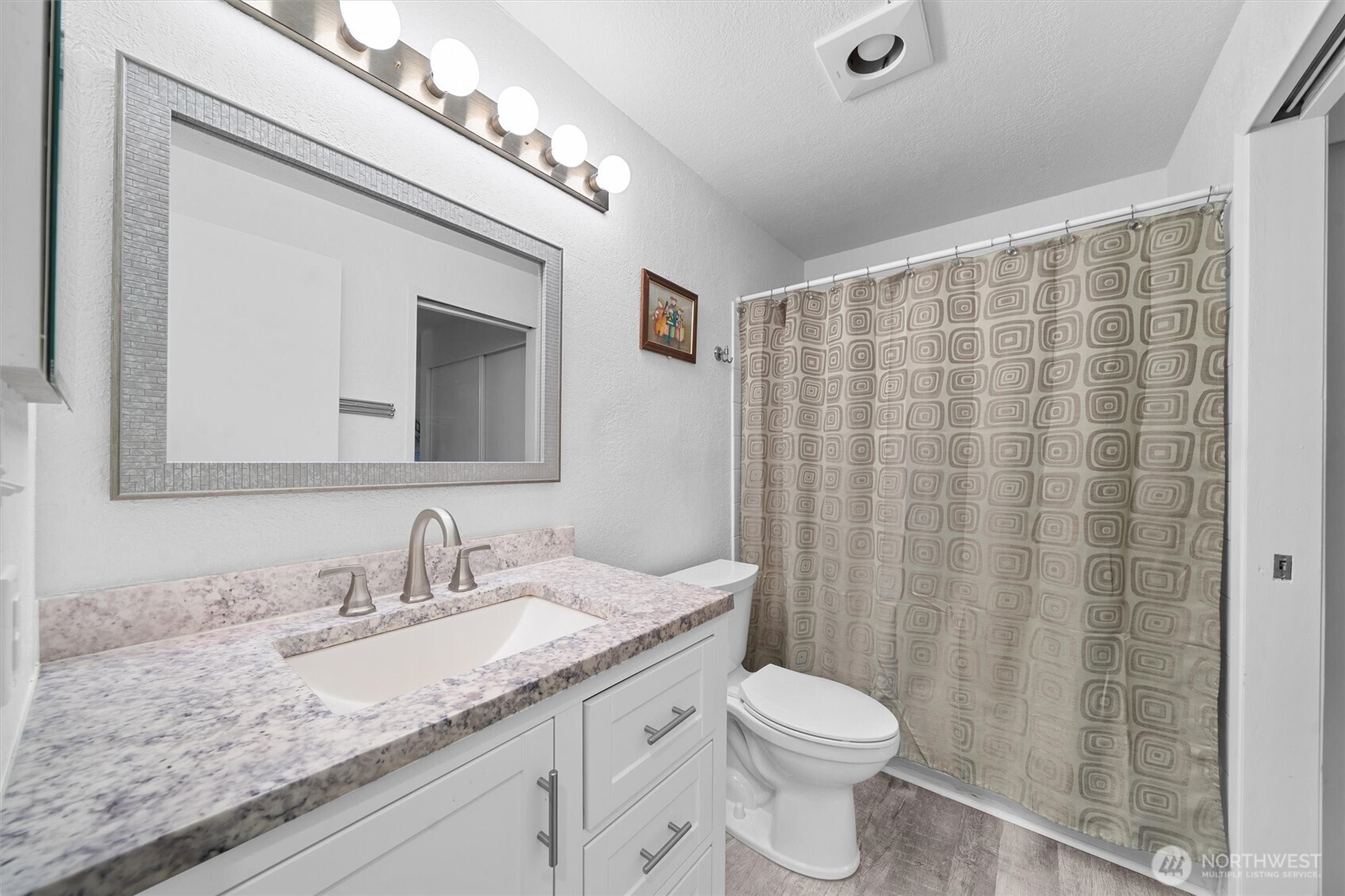 2515 Northeast 4th Street, Unit 522 Renton, WA 98056 - Photo 16 of 33 a bathroom with a granite countertop sink toilet and shower