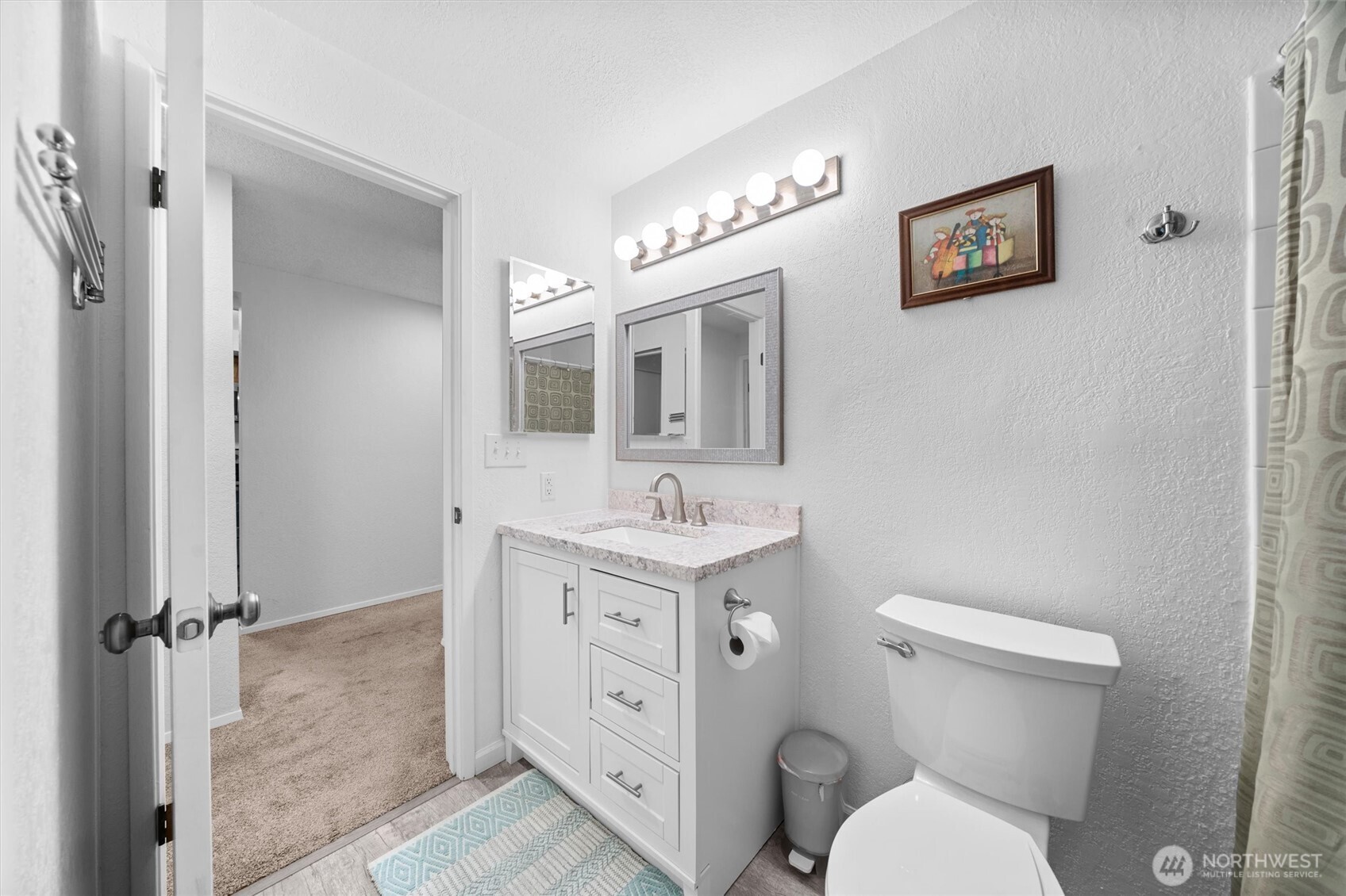 2515 Northeast 4th Street, Unit 522 Renton, WA 98056 - Photo 17 of 33 a bathroom with a toilet sink vanity and mirror