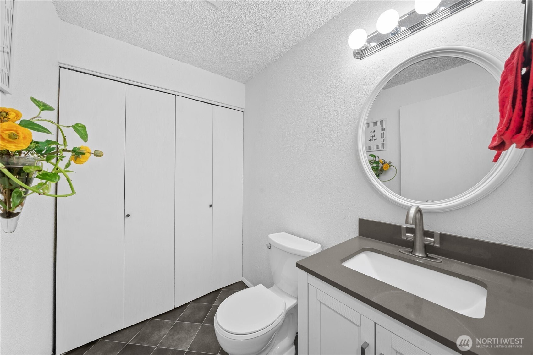 2515 Northeast 4th Street, Unit 522 Renton, WA 98056 - Photo 21 of 33 a bathroom with a sink a toilet and a mirror