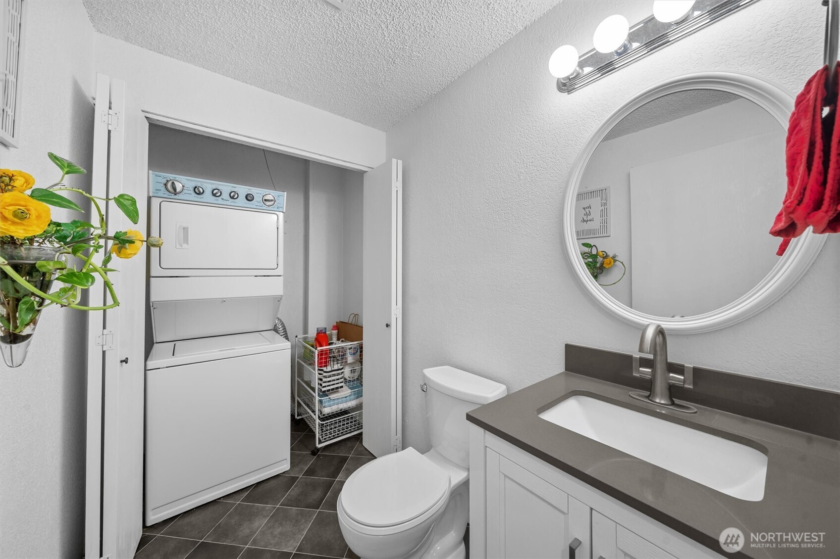 2515 Northeast 4th Street, Unit 522 Renton, WA 98056 - Photo 22 of 33 a bathroom with a sink a toilet and a mirror