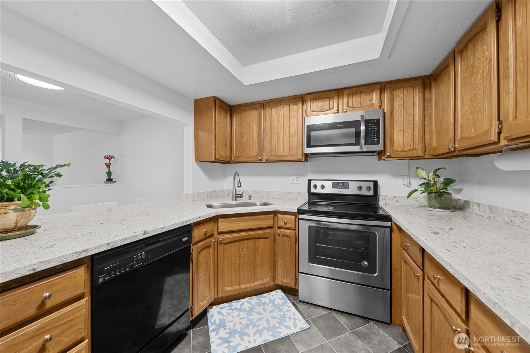2515 Northeast 4th Street, Unit 522 Renton, WA 98056 - Photo 7 of 33 a kitchen with stainless steel appliances granite countertop a sink stove and microwave