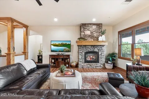 a living room with furniture a large window and a flat screen tv