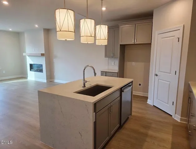 a kitchen with stainless steel appliances a sink stove and cabinets