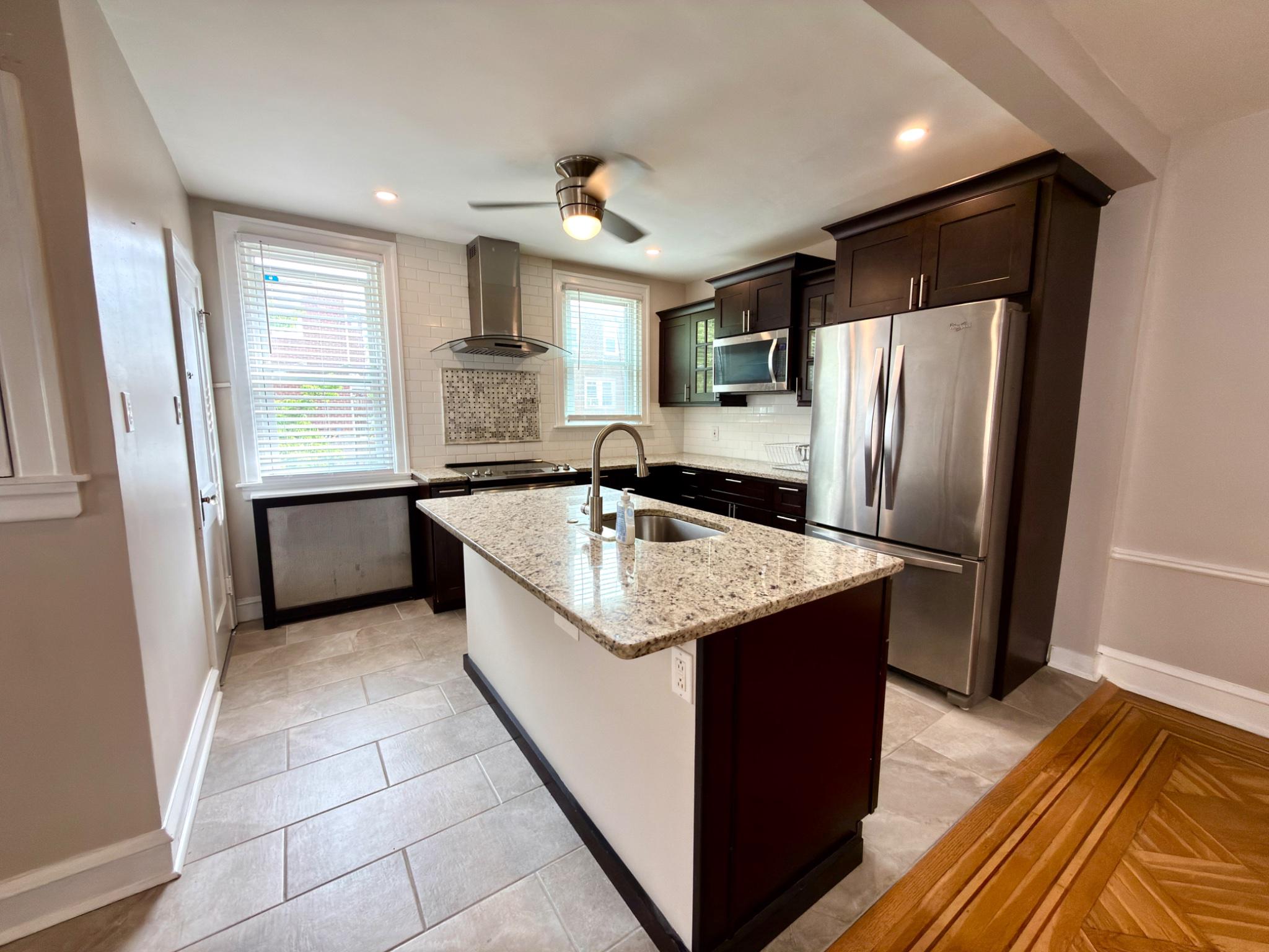 1723 Chelsea Road Elkins Park, PA 19027 - Photo 13 of 38 a kitchen with stainless steel appliances granite countertop a sink a refrigerator and a stove