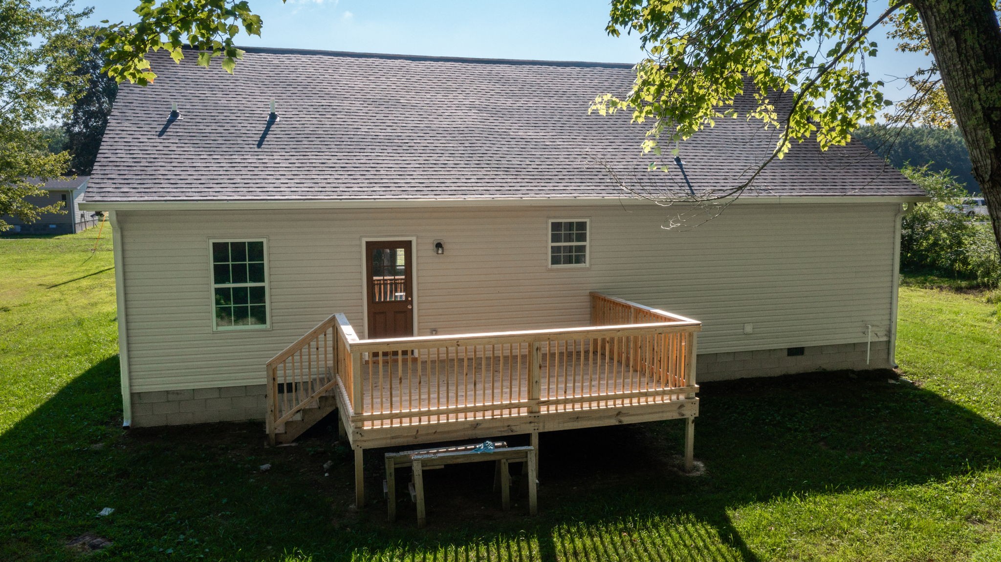 1093 Bob Meadows Road Manchester, TN 37355 - Photo 35 of 43 a side view of a house with a wooden deck and a yard