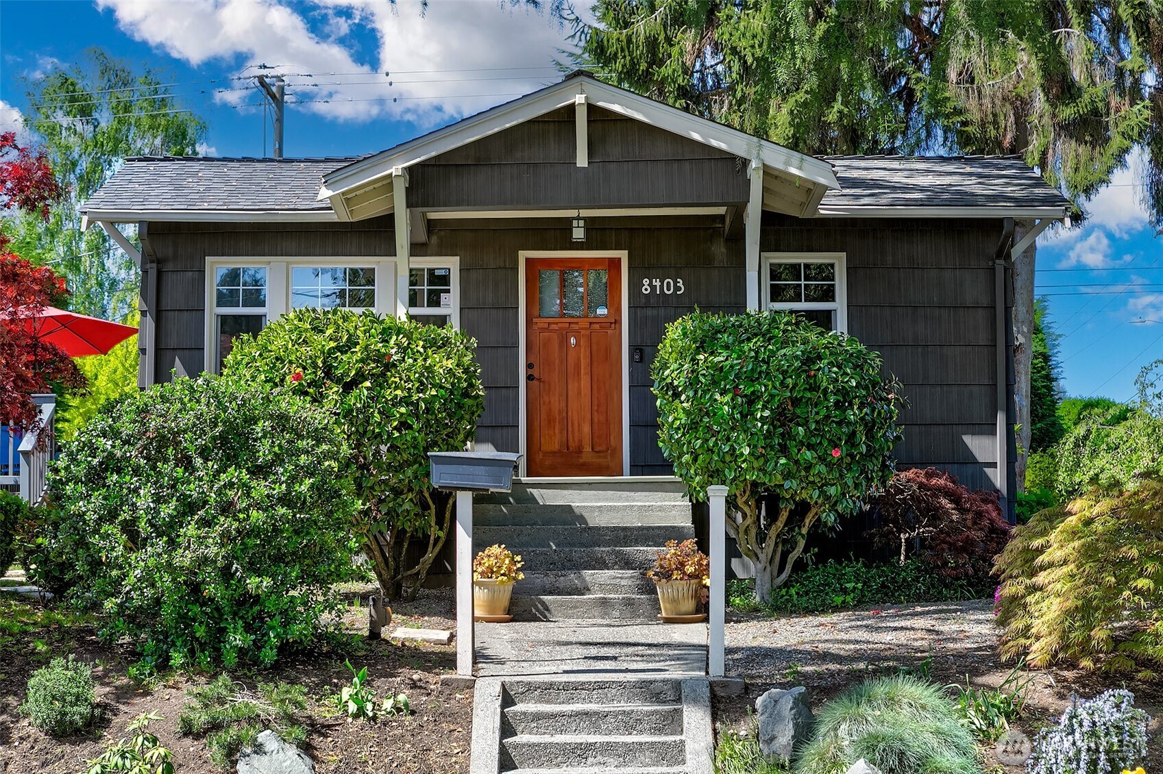 8403 32nd Avenue Southwest Seattle, WA 98126 - Photo 1 of 15 a front view of a house with garden