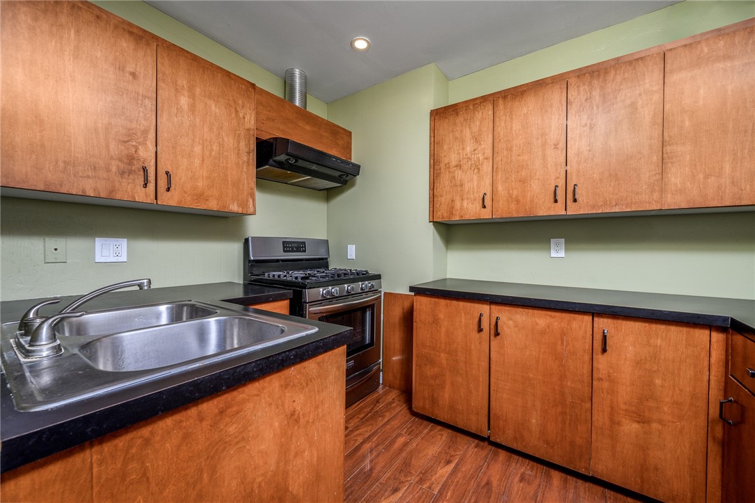 321 West Le Roy Avenue Arcadia, CA 91007 - Photo 17 of 38 a kitchen with granite countertop wooden cabinets a sink and dishwasher