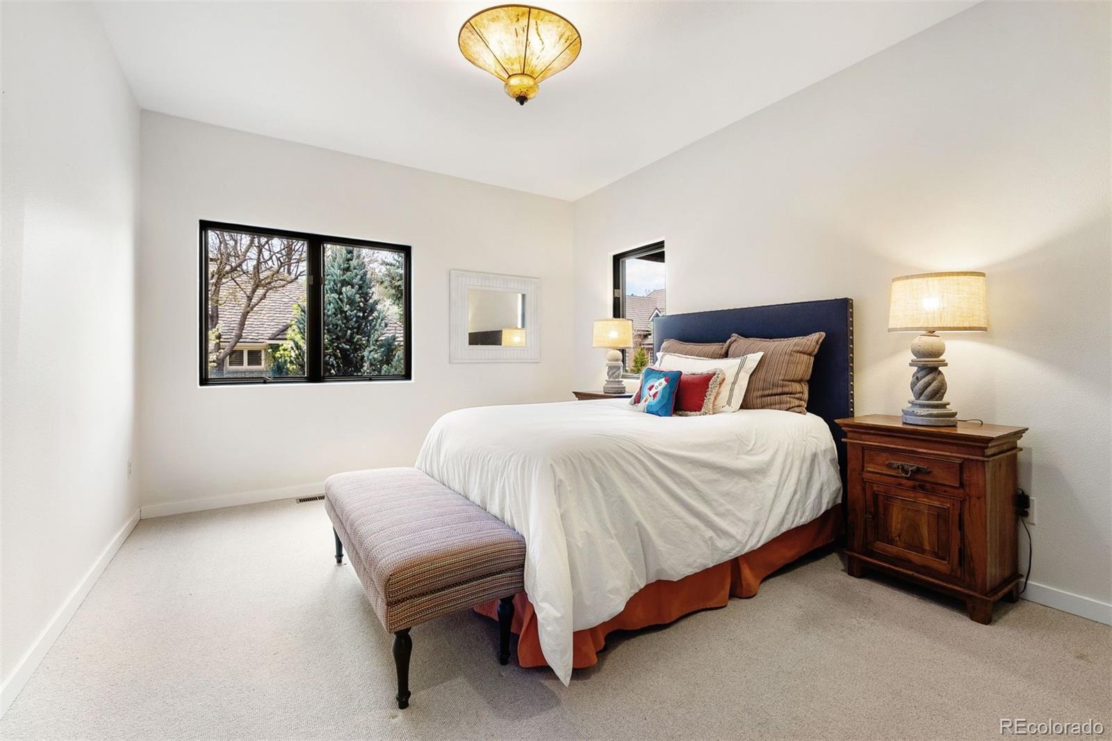 9 Polo Field Lane Denver, CO 80209 - Photo 13 of 36 a spacious bedroom with a bed and window