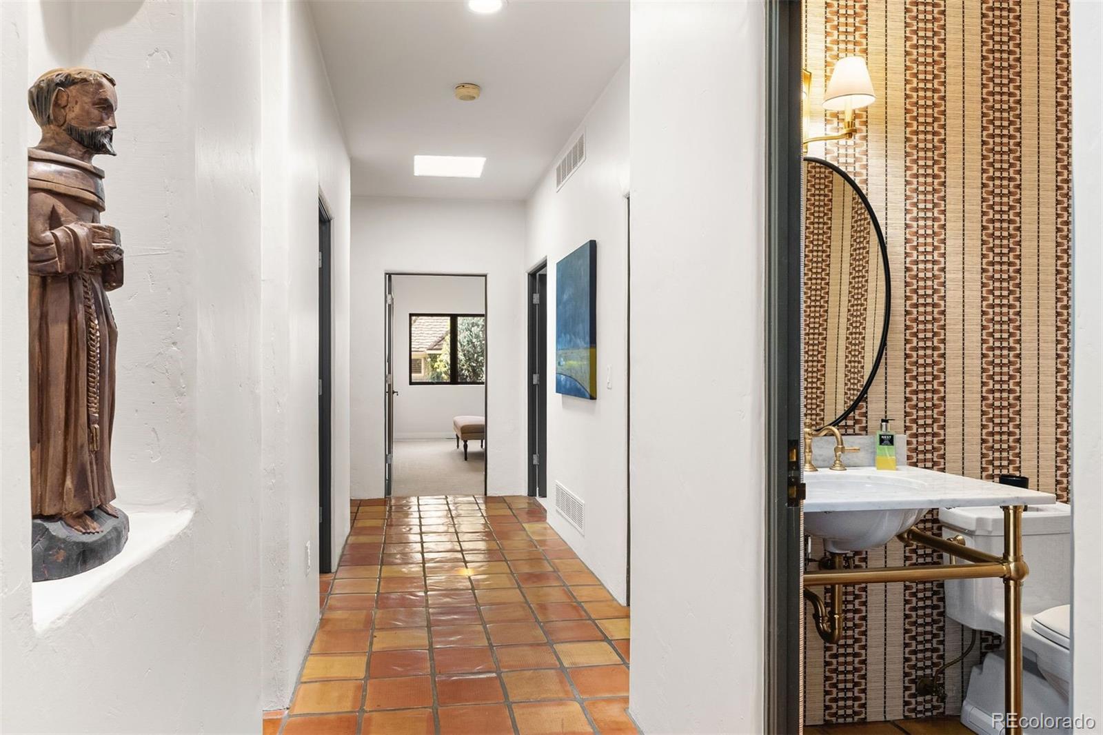 9 Polo Field Lane Denver, CO 80209 - Photo 18 of 36 a view of a hallway with wooden floor and a bathroom