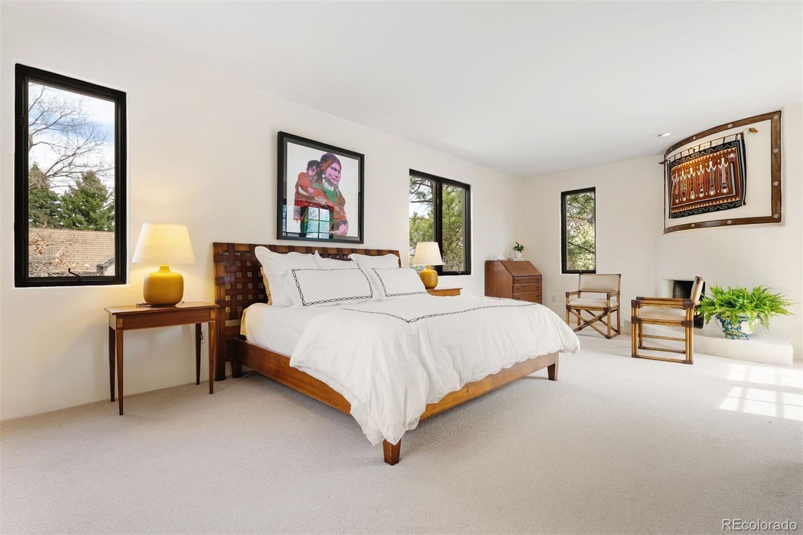 9 Polo Field Lane Denver, CO 80209 - Photo 19 of 36 a spacious bedroom with a bed and a couch