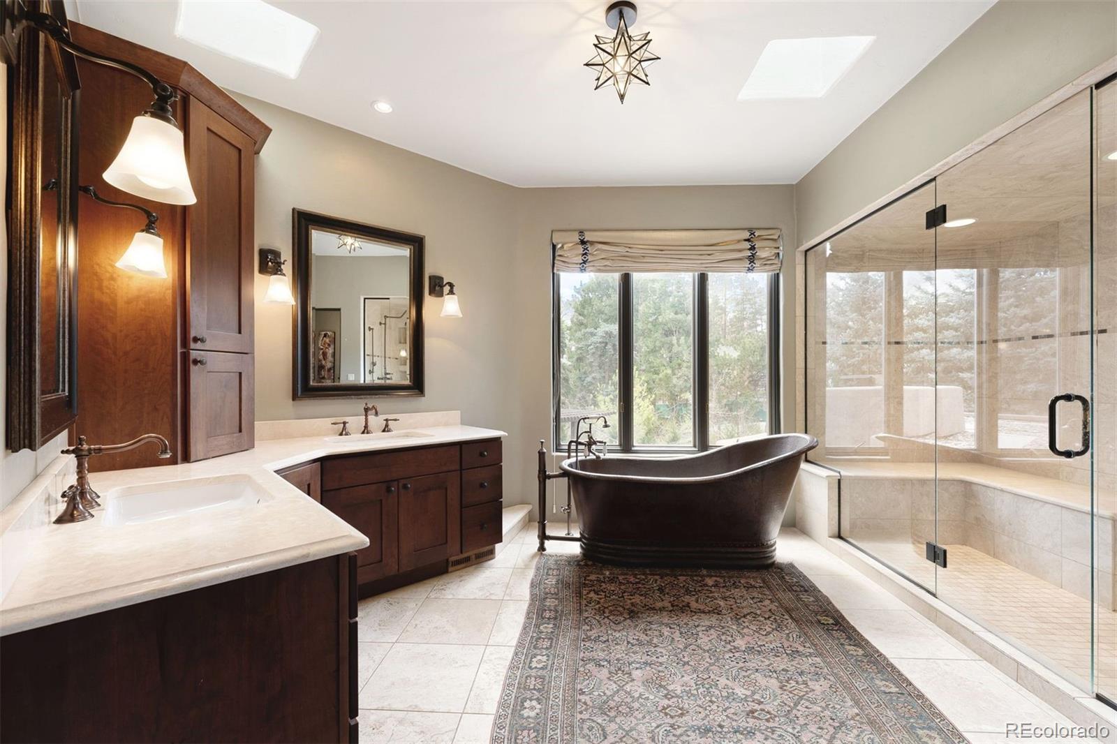 9 Polo Field Lane Denver, CO 80209 - Photo 22 of 36 a bathroom with a tub sink and mirror
