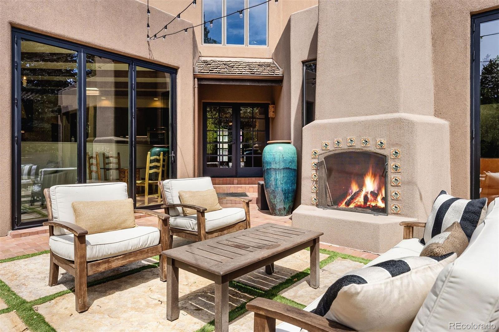 9 Polo Field Lane Denver, CO 80209 - Photo 29 of 36 a view of a patio with a dining table and chairs