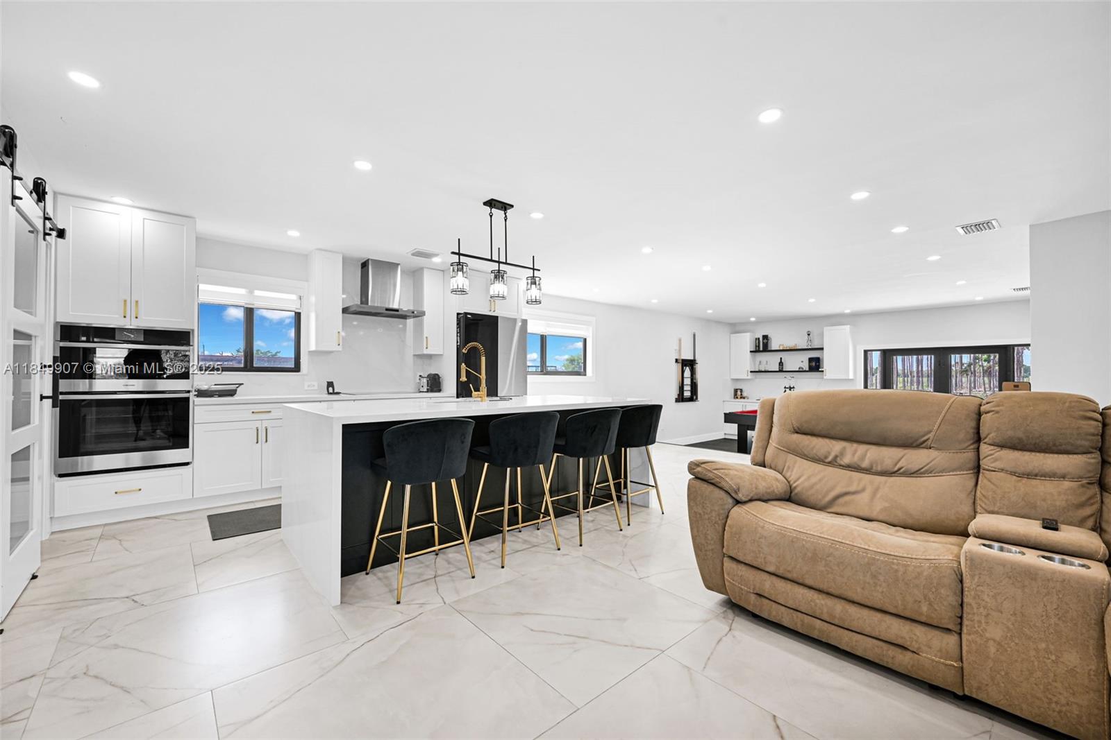 19777 Southwest 334th Street Homestead, FL 33034 - Photo 12 of 55 a living room with furniture a kitchen view and a fireplace
