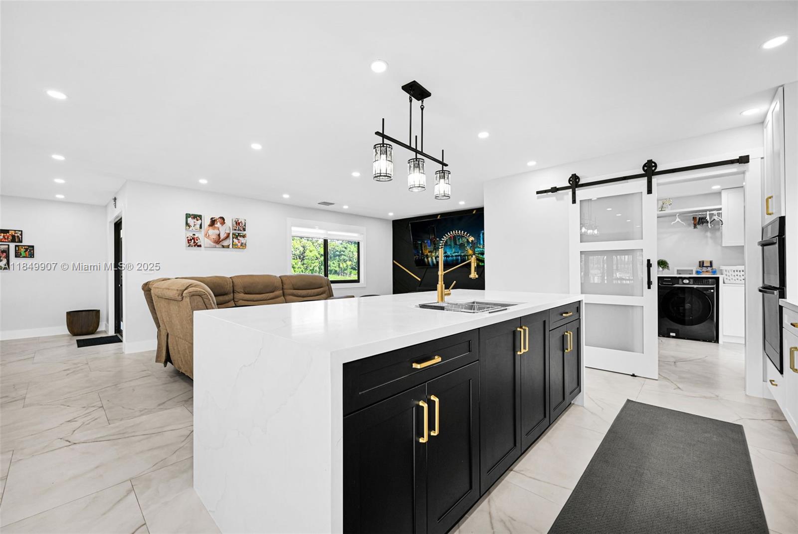 19777 Southwest 334th Street Homestead, FL 33034 - Photo 15 of 55 a kitchen with kitchen island white cabinets and refrigerator