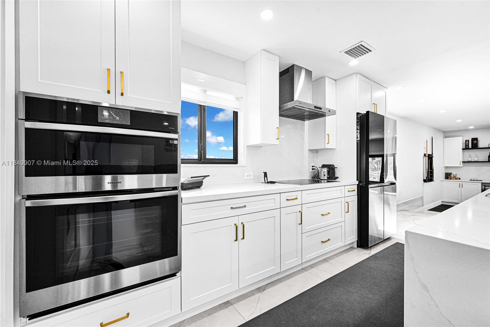 19777 Southwest 334th Street Homestead, FL 33034 - Photo 16 of 55 a kitchen with stainless steel appliances a stove a microwave and cabinets