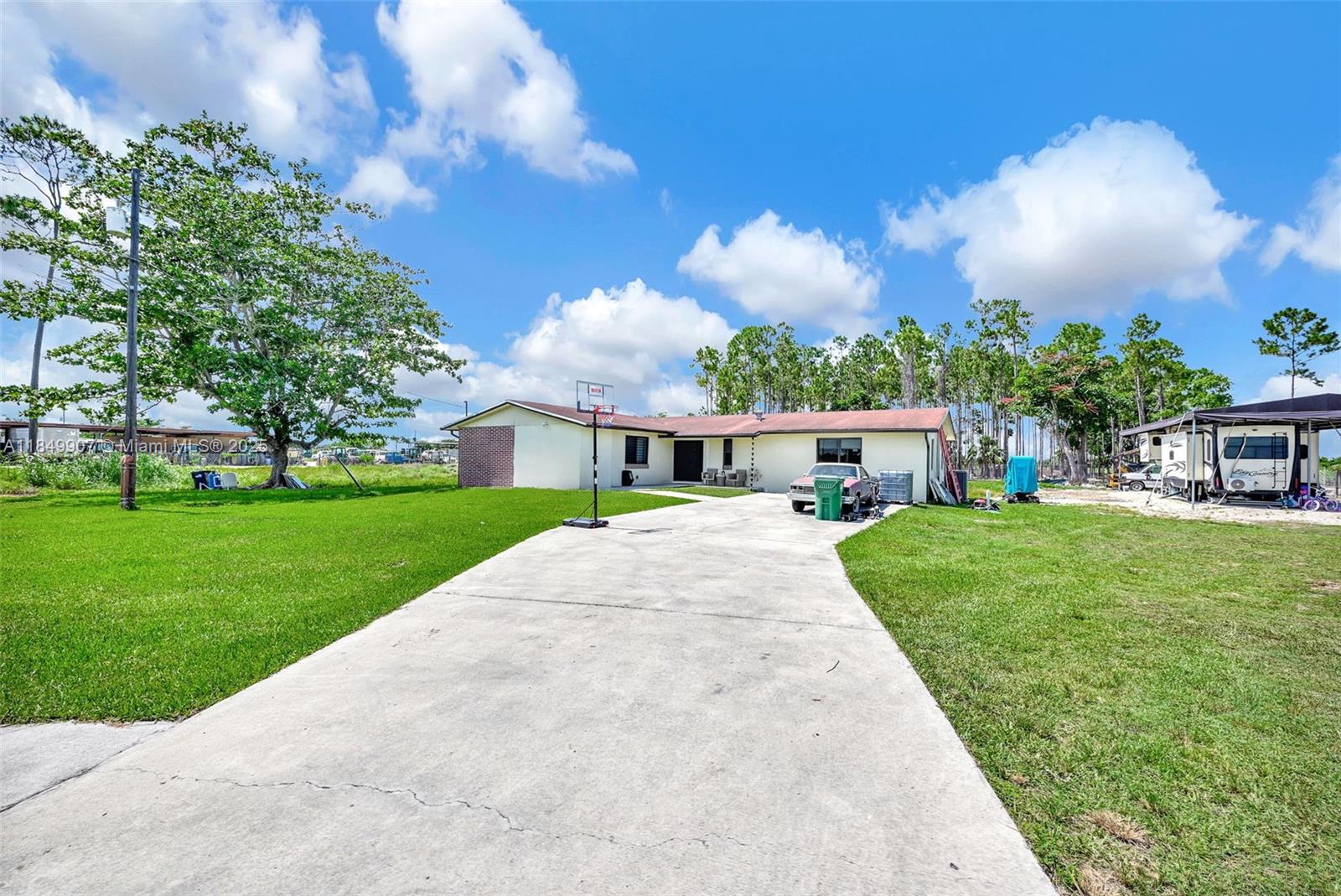 19777 Southwest 334th Street Homestead, FL 33034 - Photo 2 of 55 a front view of a house with garden